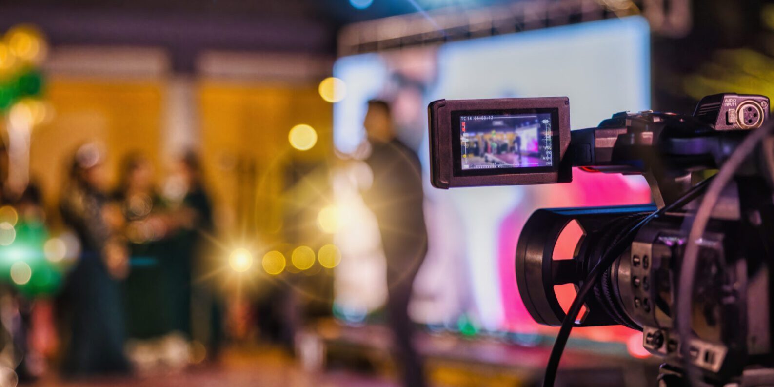 Camera filming a lively indoor event scene.